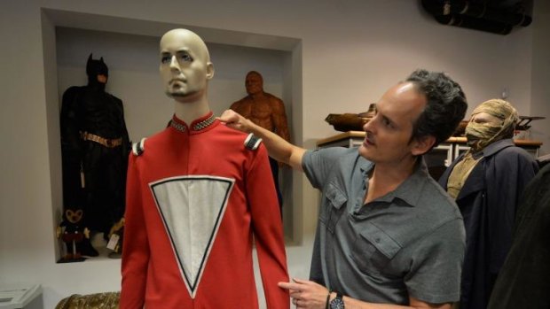Auctioneer Brian Chanes with the original Robin Williams iconic Mork spacesuit from <i>Mork and Mindy</i>.