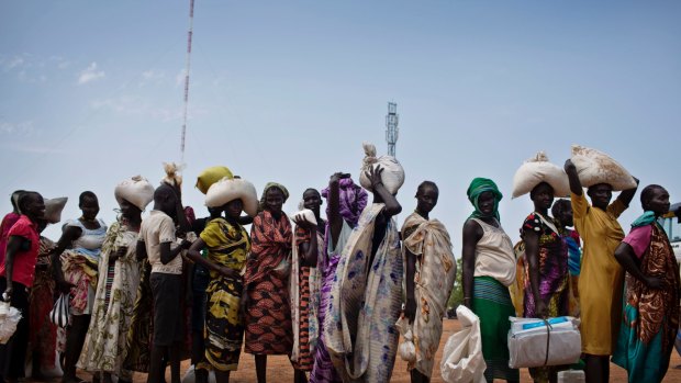 Women who fled fighting in nearby Leer in recent months, queue for food aid at a food distribution made by the World Food Programme in Bentiu, South Sudan. 