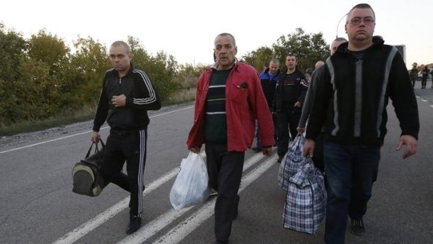 Motley crew: Pro-Russian prisoners-of-war walk along a road as they wait to be exchanged near Donetsk.