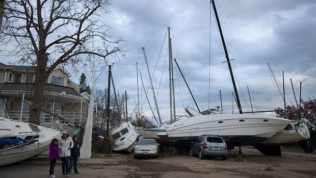 Hit hard ... a boat is dumped on top of cars on Staten Island, which was smashed by huge storm surge.