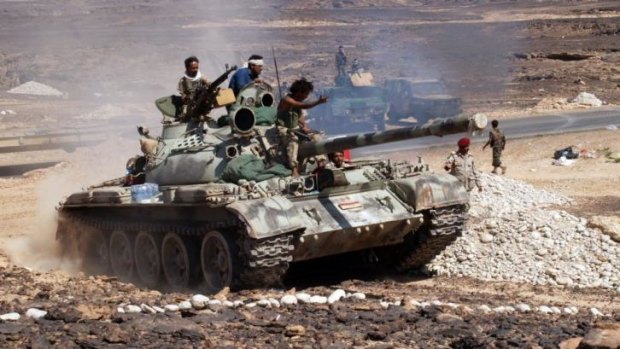 Crackdown: Yemeni soldiers ride a tank after taking hold of an Al-Qaeda stronghold . The Yemeni government has expanded its offensive against al-Qaeda, including drone strikes.