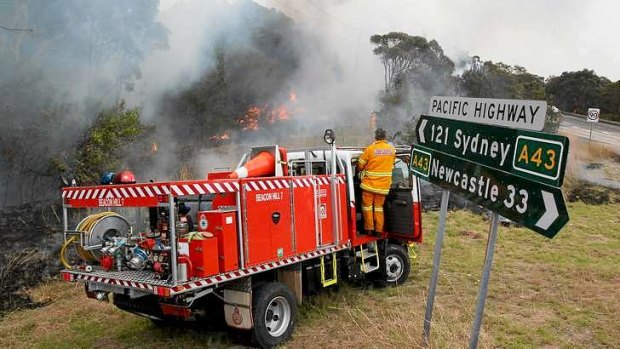 At the crossroads: Firefighters on the corner of the Pacific Highway and Flowers Drive.