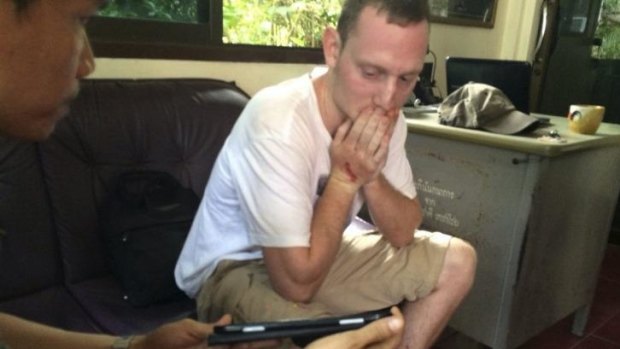 Christopher Ware, a British friend of British tourist David Miller who was killed along with his girlfriend, reacts during an investigation at a police station. 