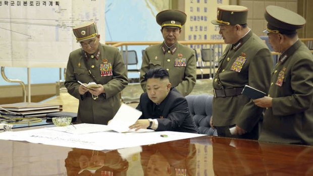 Kim Jong-un discusses the strike plan with North Korean officers.