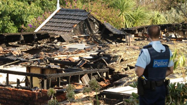 A policeman surveys the scene of the blast at Berwick which destroyed the $1 million home.