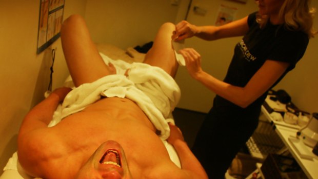 Darren, a stripper from Hunkmania, is waxed by beauty therapist Amber at Men's Body Works.