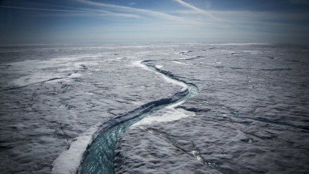 Meltwater flows along a supraglacial river on the Greenland ice sheet in July. The ice sheet is one of the biggest and fastest-melting chunks of ice on Earth