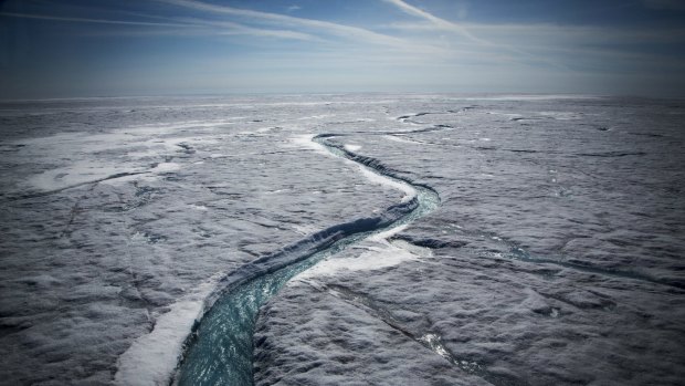 Meltwater flows along a glacial river on the Greenland ice sheet last July.