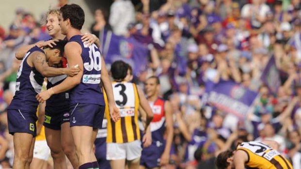 Fremantle players celebrate their five-goal win over Hawthorn in the second elimination final at Subiaco Oval.