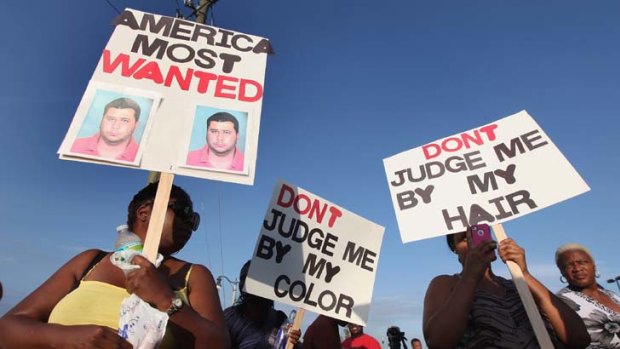 Angered ... protesters demonstrate at a rally for slain teenager Trayvon Martin.