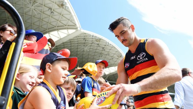 Walker signs an autograph before the Crows flew to Melbourne.