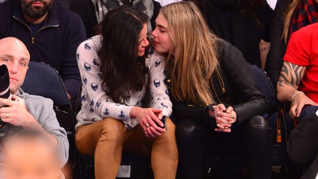 Michelle Rodriguez and Cara Delevingne attend the Detroit Pistons vs New York Knicks game at Madison Square Garden on January 7, 2014 in New York City.