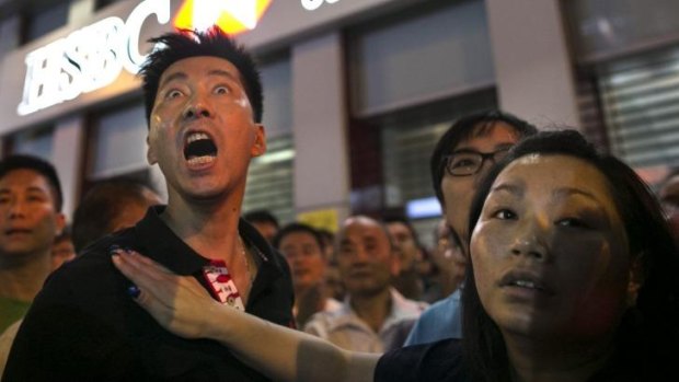 Residents of Kowloon who are pro-Beijing scream at the student democracy protesters to "get out" in the Mong Kok neighbourhood. 