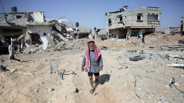 A Palestinian man surveys the damage caused by an Israeli air strike in southern Gaza.