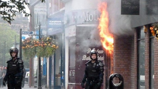 Violence spreading ... fire rips through a retail store in Manchester city centre.