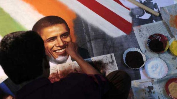 Getting the picture: An artist in Thane, near Mumbai, creates a portrait of Barack Obama on the eve of the leader’s three-day visit to India.