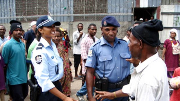 A new era...an Australian and a Papua New Guinean officer meet residents on a joint patrol in Port Moresby.