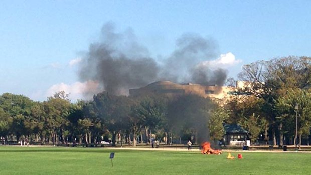 Later that day, people rush to help a man who apparently set fire to himself in the National Mall.