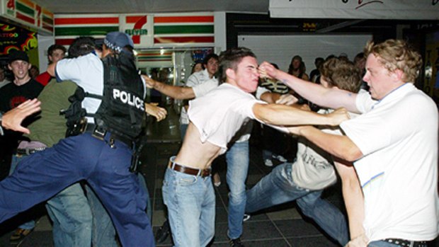 Drinking and fighting ... a brawl erupts during a previous Schoolies Week on the Gold Coast.