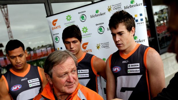 Giants... Israel Folau, Jonathon Patton and Jeremy Cameron stand to attention as Kevin Sheedy addresses the media.