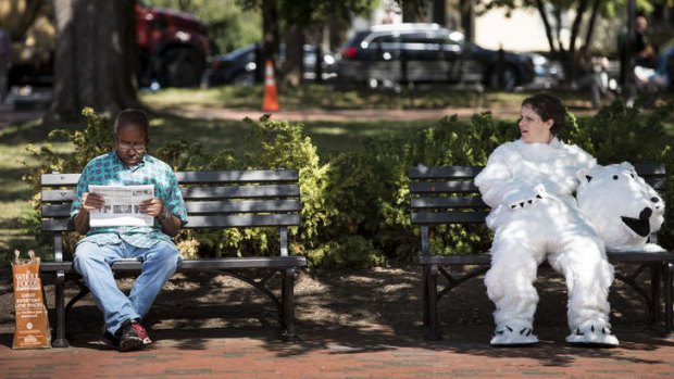 Dressed as a polar bear, Megan Gabriel, an activist with the Sierra Club, rests on a bench during a protest in Washington, DC against arctic drilling.