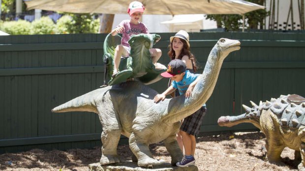 Children play with the creatures at Palmersaurus dinosaur park.