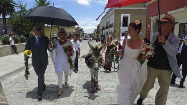 Michael Shmith (left) joins the bride who is leading her celebratory donkey.