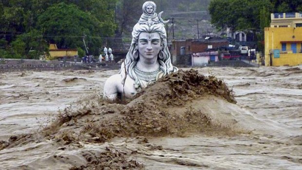 Monsoon nightmare: A submerged idol of Hindu Lord Shiva stands in the flooded River Ganges in Rishikesh.
