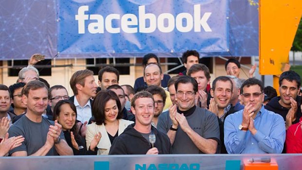 Facebook co-founder Mark Zuckerberg (centre) with staff at the company's headquarters. He rang the bell to open the trading in Facebook shares in May remotely.