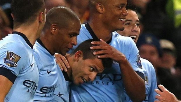 Manchester City's Sergio Aguero (C) celebrates with team mates after scoring.