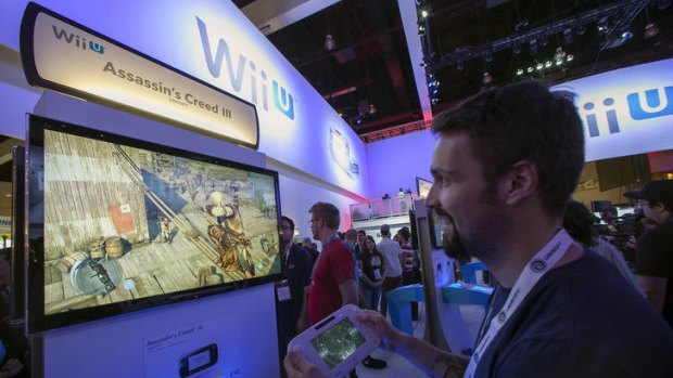 Nicolas Duclos, a developer with Ubisoft Entertainment, showcases the new Assassin's Creed III game on the Nintendo Wii U console at the E3 expo.