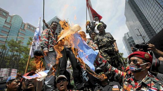 Indonesian protesters burn a mock Australian flag during a demonstration outside Australian Embassy in Jakarta on Thursday