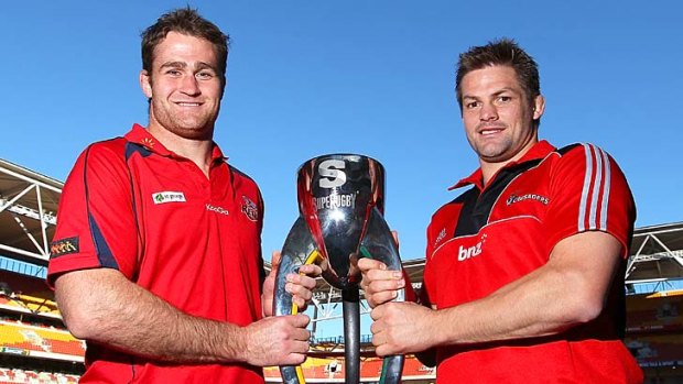 Opposing captains James Horwill of the Reds and Richie Mccaw of the Crusaders with the coveted Super Rugby trophy.