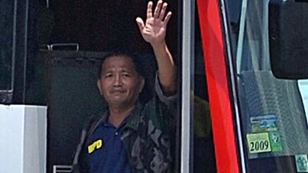 Rolando Mendoza, armed with a high-powered assault rifle,  waves from the bus he held Hong Kong tourists on before the bloodshed began.