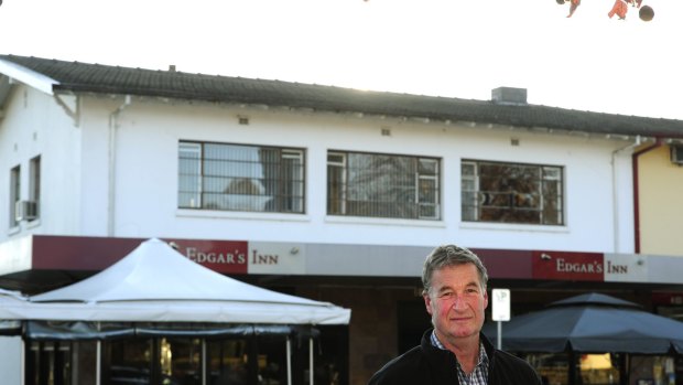 Jeff Darwin in 2015 outside his Ainslie shops building. The rood space in the flat above Edgar's Inn contains loose-fill Fluffy asbestos insulation.