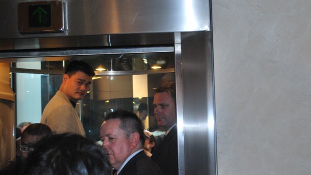 Crowded lift...life can be pretty squashy for Chinese basketball star Yao Ming.