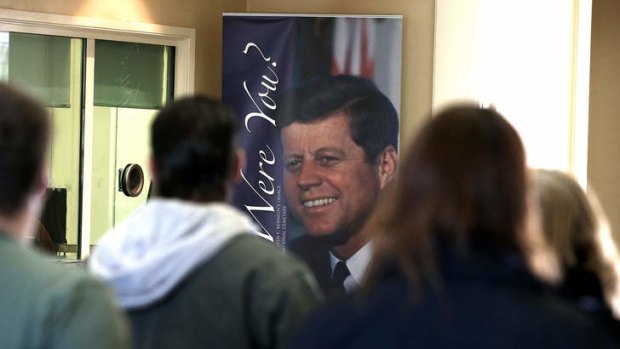 Tourists walk through the welcome centre at Arlington Cemetery. The US public still struggles to come to grip with the facts of John Kennedy's assassination.