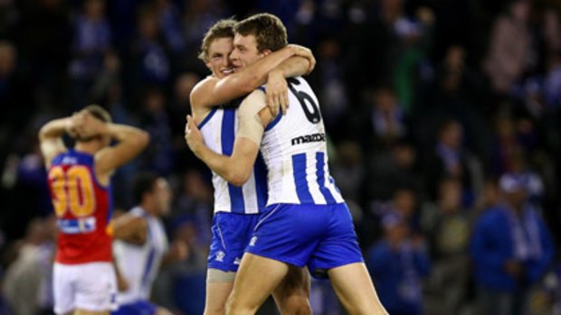 Ziebell and Lachlan Hansen of the Kangaroos celebrate their win in the round 11 AFL match between the North Melbourne Kangaroos and the Brisbane Lions at Etihad Stadium.