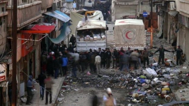 Much needed supplies: Syrian Arab Red Crescent trucks arrive in Homs to distribute aid.