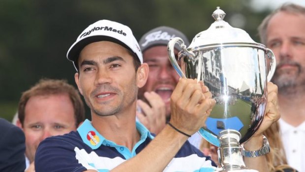 Camilo Villegas poses with the Sam Snead Cup after winning the Wyndham Championship.