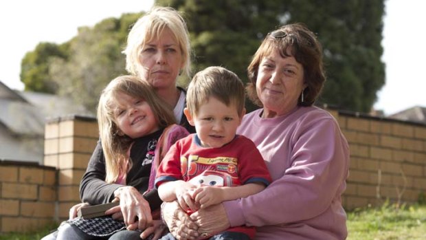 Five-year-old Monique  with grandmother Debbie Johnston and three-year-old Jack with grand mother Yvonne Richards waiting for Jason Richards to return to his Ballarat home.
