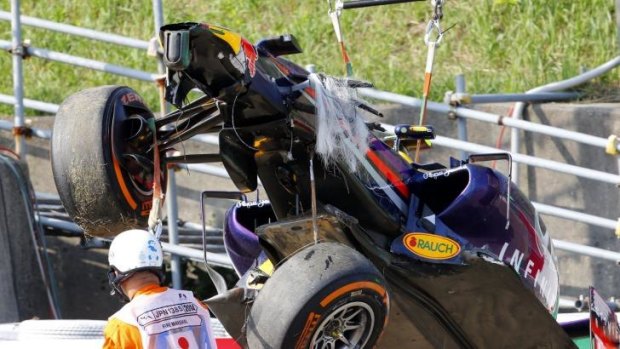 Daniel Ricciardo's Red Bull Racing car is removed from the track after his mishap in practice.