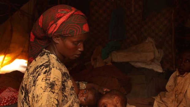 Distressing ... Yaray Bule Ibrahim gazes on her seriously ill daughter Farahiya, 2, as she nurses four-month-old Fardosa in a Kenyan refugee camp.