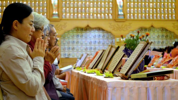 Sombre: The Chinese Buddhist community in Perth held a special prayer ceremony for the missing passengers of flight MH370 and their relatives and friends.