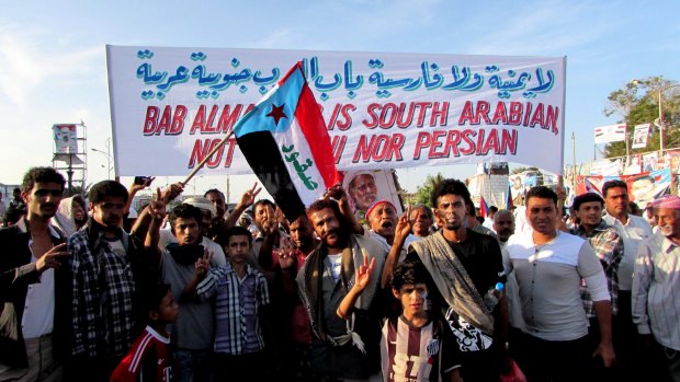 Yemenis who support independence for the country's south and oppose the "Persian" Shiite Houthi militia hold the defunct flag of Marxist South Yemen at a protest.