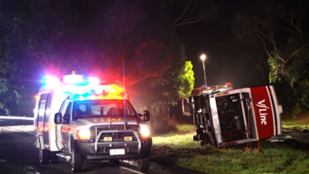 Three killed ... a V/Line bus rests on its side after a crash near Portland in Victoria.
