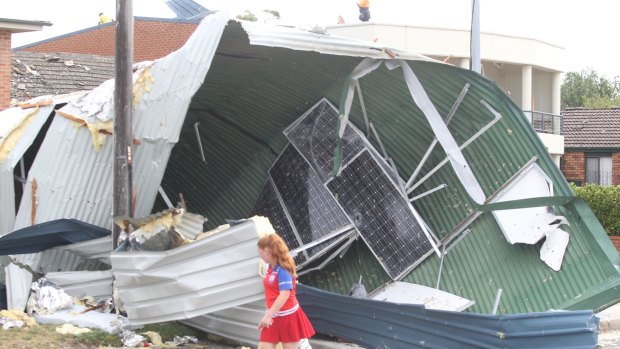 A girl surveys the damage in a residential street after a tornado hit Kurnell in December.