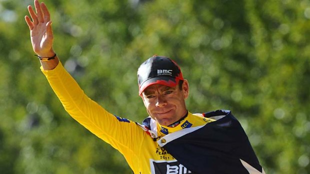 Cadel Evans celebrates on the podium after he won the 2011 Tour de France.