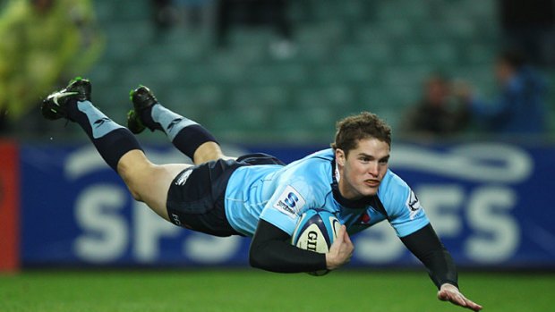 On the up ... Josh Holmes scores a try for the Waratahs against the Highlanders this weekend.