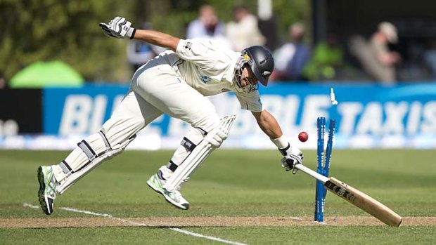 Ross Taylor just manages to beat a sharp return.